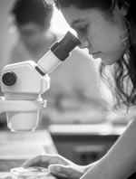student with microscope