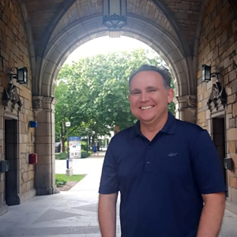 Dr. Michael Trevathan, Instructor in Political Science, School of Public Policy, stands under the Weatherford Hall arch.